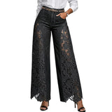 Black lace pants worn by a person on a plain background