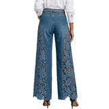Blue jeans with lace detailing on a white background