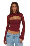 Woman wearing a burgundy long-sleeve top with mesh panels and light blue jeans on a white background
