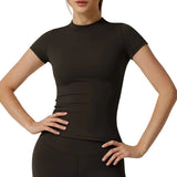 Person wearing a black short-sleeve top on a plain background