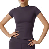 Person wearing a fitted purple athletic top and leggings on a light gray background