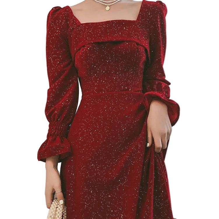 Red glittery dress with long sleeves and a square neckline against a neutral background.