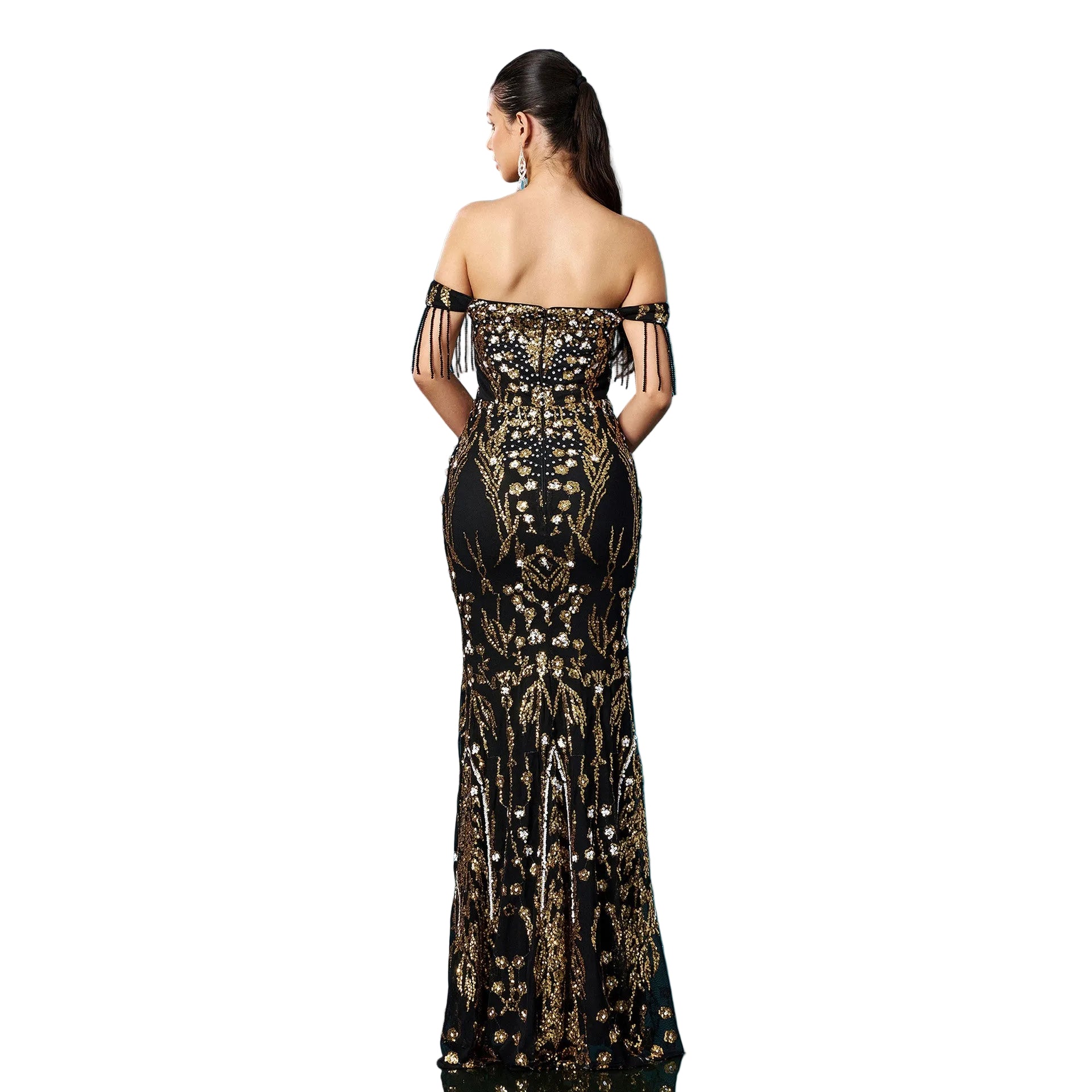 Woman wearing a black and gold evening gown against a blue background